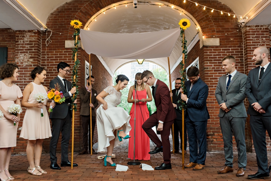 A bride and groom stomp on the glass under the chuppah at the end of their jewish wedding in Philadelphia.